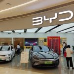 BYD showroom with cars on display and people shopping