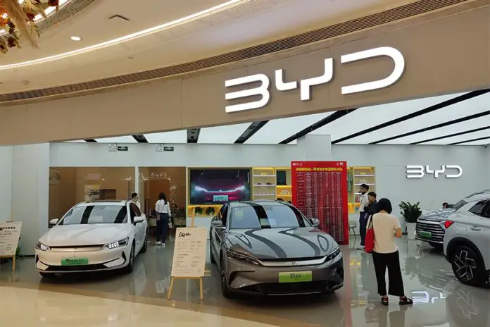 BYD showroom with cars on display and people shopping