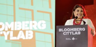 Clara Brugada behind a podium at Bloomberg CityLab 2024 in Mexico City, in the middle of a speech.