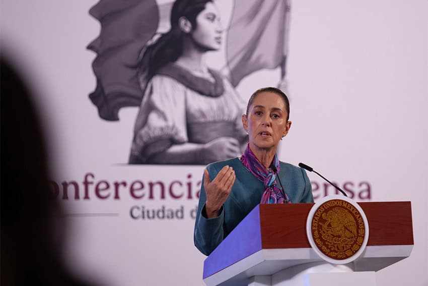 Mexico's President Claudia Sheinbaum behind a podium at a press conference in the National Palace.