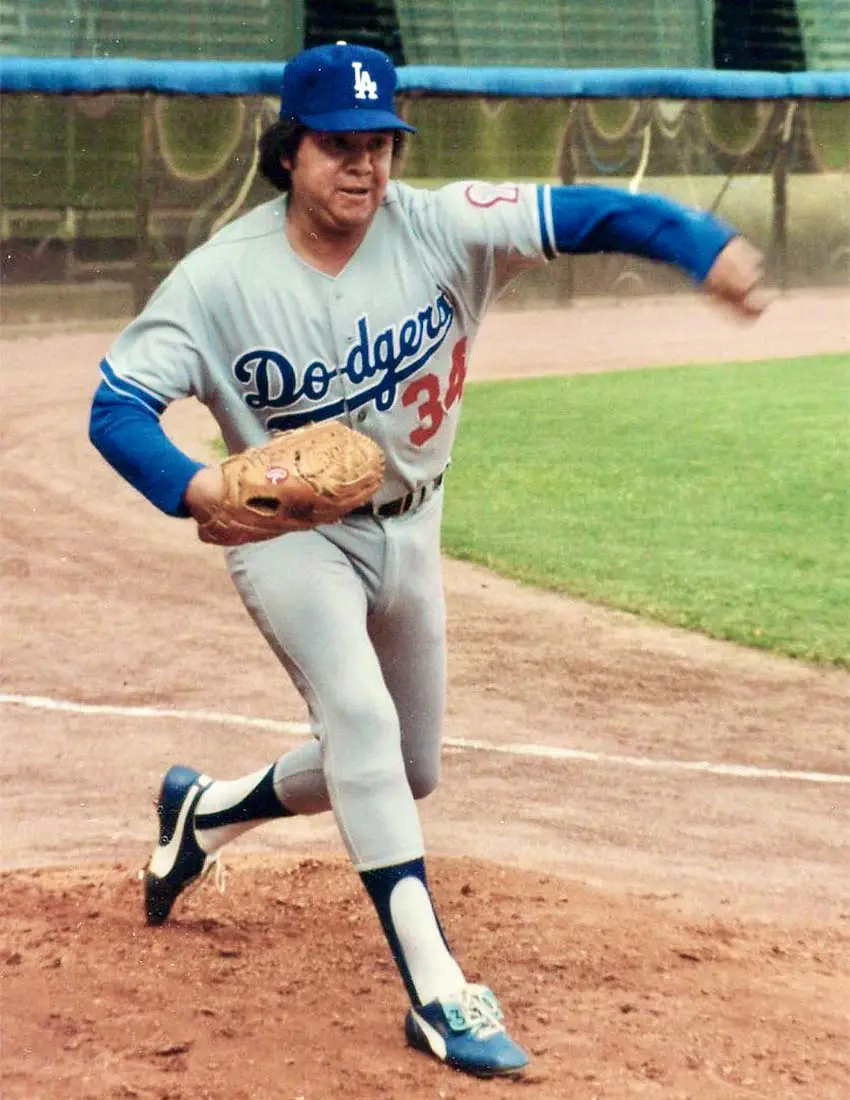 Fernando Valenzuela in his Los Angeles Dodgers uniform the Dodgers bullpen, in motion from having just thrown a baseball.