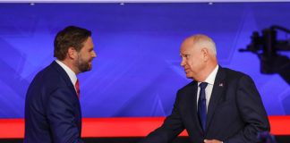 JD Vance and Tim Walz at the vice presidential debate shaking hands before they begin