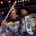 Two members of Los Tigres del Norte play guitar and accordion