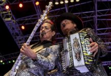 Two members of Los Tigres del Norte play guitar and accordion