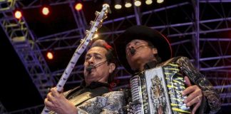 Two members of Los Tigres del Norte play guitar and accordion