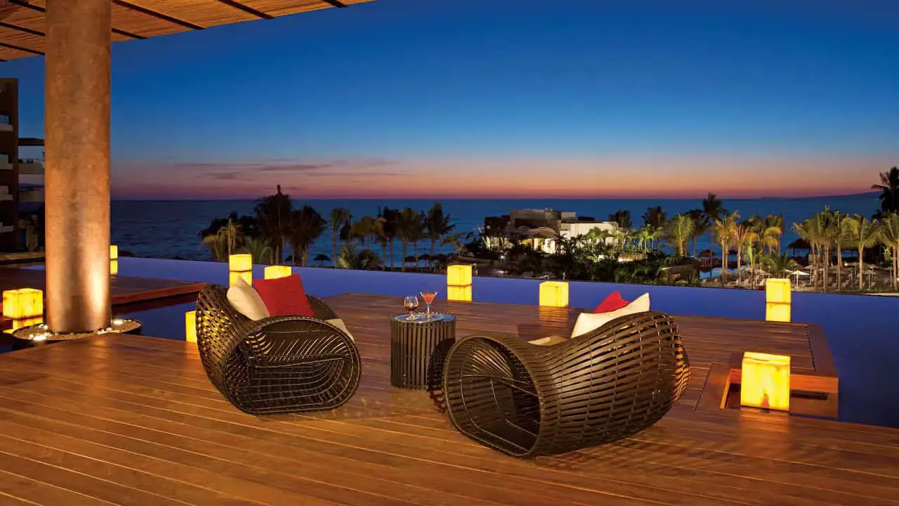 Two chairs on the edge of a pool at Secrets Vallarta