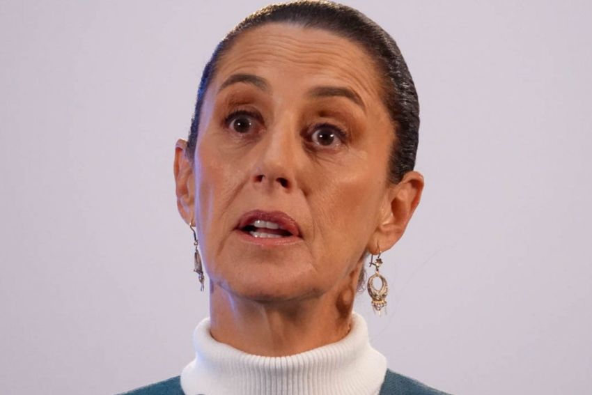 Closeup shot of Mexican President Claudia Sheinbaum at a press conference with an expression suggesting she's listening to a reporter