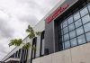 The entrance to Avery Dennison's new plant in Querétaro, showing the company name in red letters