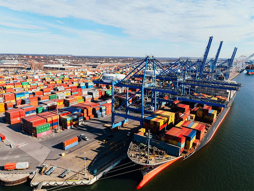 Cranes load containers off cargo ships in the Baltimore shipyard