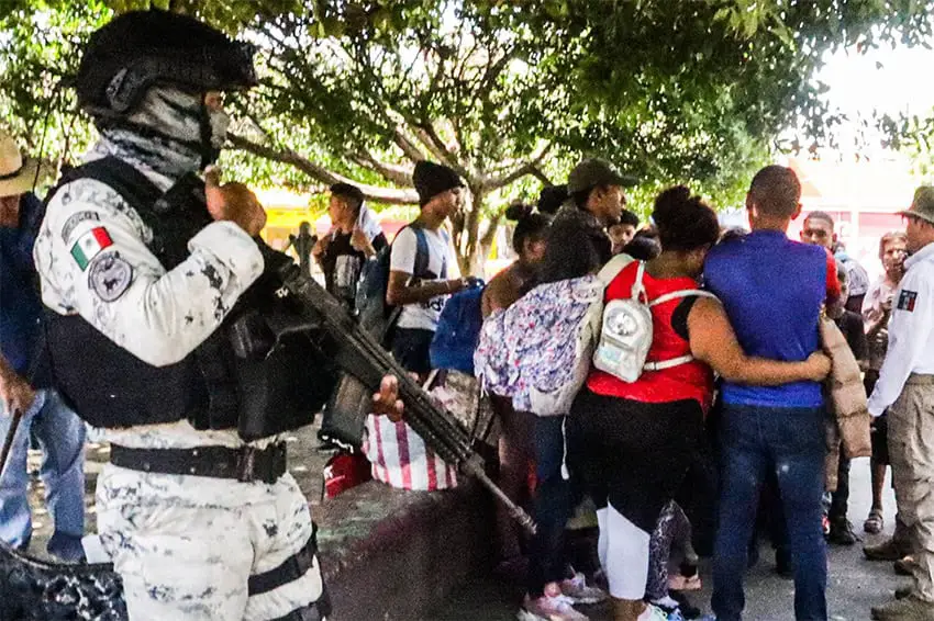 An armed member of the National Guard detains Venezuelan migrants in Chiapas earlier this year