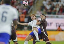 Mexican player disputes a ball with the American opponent.