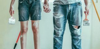 A couple painting a house