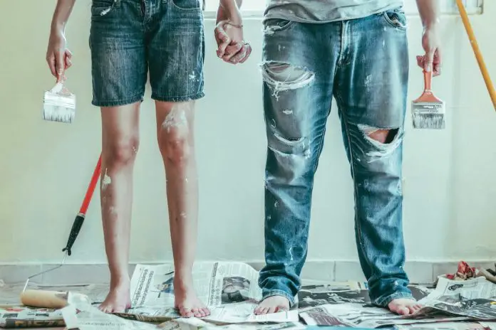 A couple painting a house