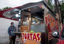 A torta truck with hand-painted signs advertising their product