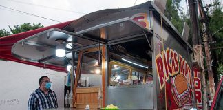 A torta truck with hand-painted signs advertising their product
