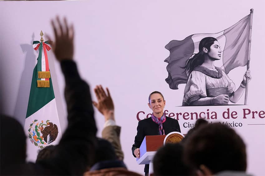 Reporters raise their hands to ask President Sheinbaum questions at her morning press conference