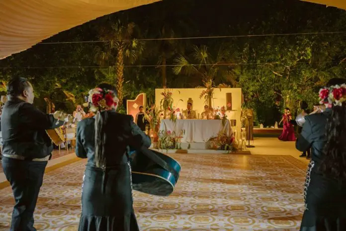 Mariachi serenades bride and groom at wedding. Mexican wedding traditions