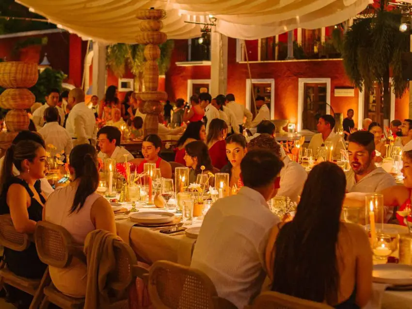 Guests at a wedding seated around a table. Mexican wedding traditions