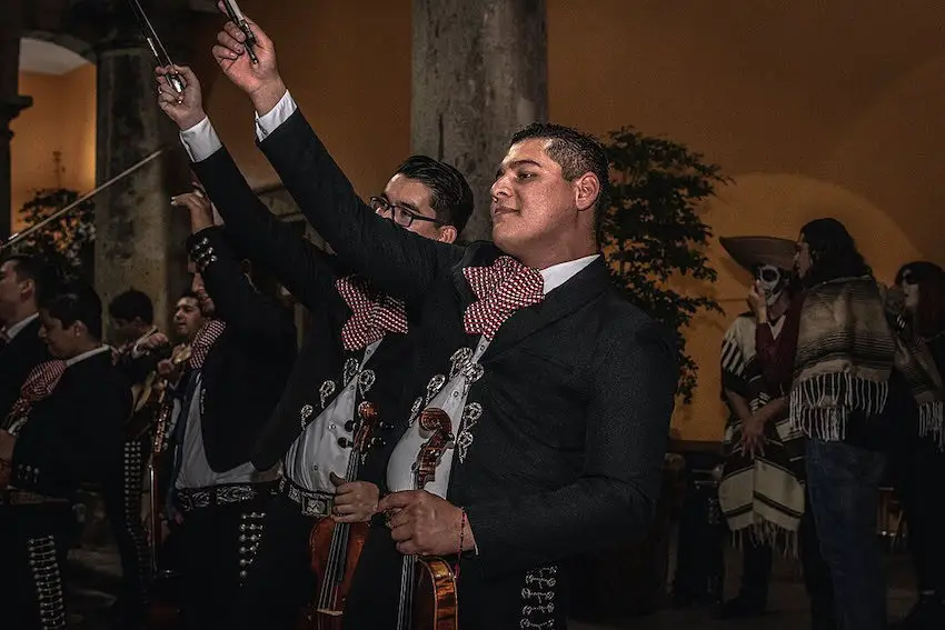 Two charro men, dressed in their typical attire.