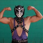 A traditional Mexican luchador poses for the camera.