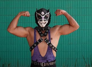 A traditional Mexican luchador poses for the camera.