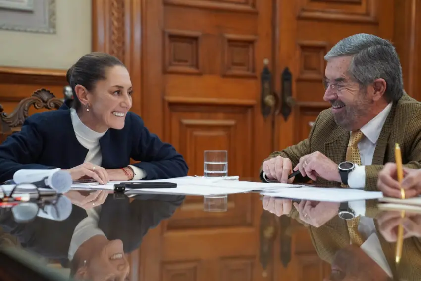 Mexico's president Claudia Sheinbaum in the national palace on a call with Donald Trump looking at Mexico's Foreign Affairs Minister Juan Ramón de la Fuente who sits aside from her at the same table.