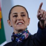 Mexico's President Claudia Sheinbaum taking a reporter's question with her finger pointing at a reporter off camera