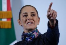 Mexico's President Claudia Sheinbaum taking a reporter's question with her finger pointing at a reporter off camera