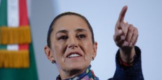 Mexico's President Claudia Sheinbaum taking a reporter's question with her finger pointing at a reporter off camera