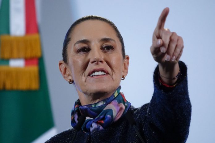 Mexico's President Claudia Sheinbaum taking a reporter's question with her finger pointing at a reporter off camera