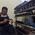 A Mexican shoe-maker at work