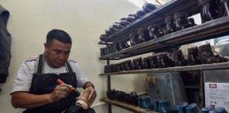 A Mexican shoe-maker at work