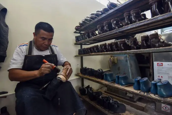 A Mexican shoe-maker at work