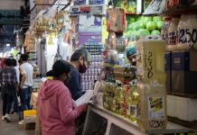 Residents fill their list at a grocery store, at the Central de Abastos, Mexico City.