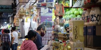 Residents fill their list at a grocery store, at the Central de Abastos, Mexico City.