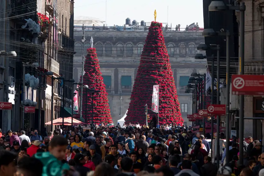 As part of the December holidays, hundreds of people walk along Madero Street in the Historic Center.