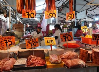 A carnicería displays meat cuts and prices