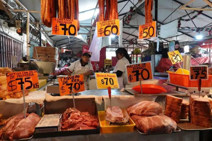 A carnicería displays meat cuts and prices