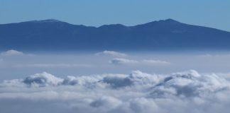 Volcanoes peak through the clouds during a cold front