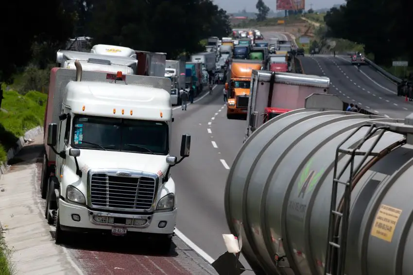 Two lanes of tractor trailers on the Mexico-Puebla highway in Mexico