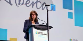 Canadian politician and Alberta Premier Danielle Smith speaks at a microphone