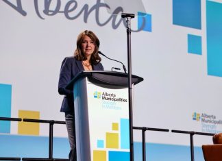 Canadian politician and Alberta Premier Danielle Smith speaks at a microphone