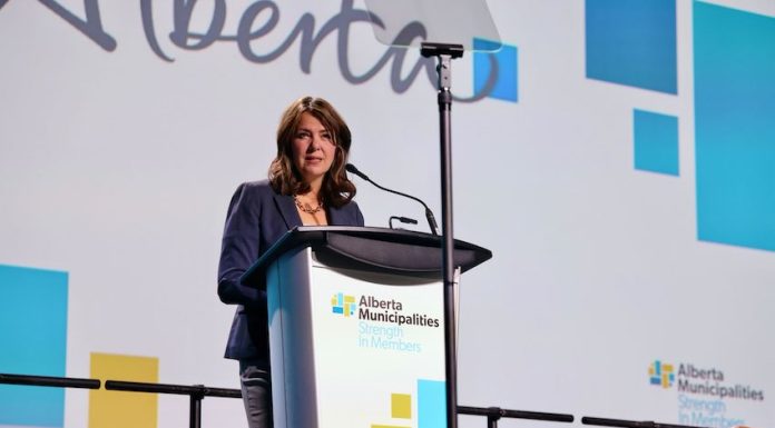 Canadian politician and Alberta Premier Danielle Smith speaks at a microphone