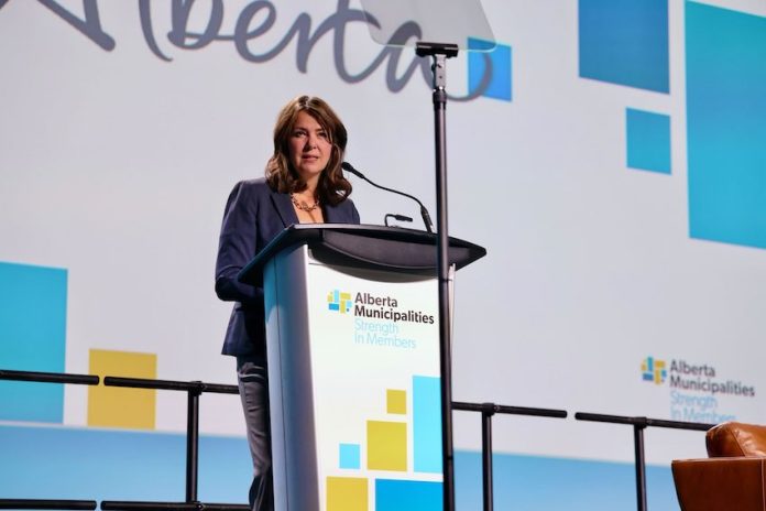 Canadian politician and Alberta Premier Danielle Smith speaks at a microphone