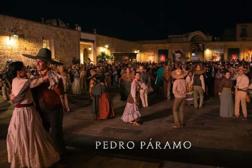 Townspeople dance in a dimly lit plaza, in a scene from the Netflix adaptation of "Pedro Páramo."