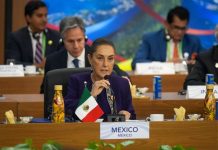 President Claudia Sheinbaum speaks into a microphone at the G20 summit in Rio de Janeiro, Brazil