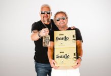 Celebrity chef Guy Fieri, left, and rocker Sammy Hagar, right, holding boxes and a bottle of their brand of tequila, Santo as they pose for a publicity photo