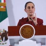 Mexican President Claudia Sheinbaum addresses tariffs on Mexico at a podium during her daily press conference