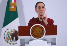 Mexican President Claudia Sheinbaum addresses tariffs on Mexico at a podium during her daily press conference