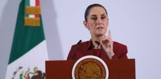 Mexican President Claudia Sheinbaum addresses tariffs on Mexico at a podium during her daily press conference